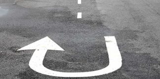 U-turn arrow painted on asphalt road