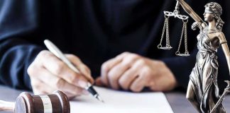 Top Cop LIED — Texas Conviction OBLITERATED Judge writing at desk with gavel and Lady Justice statue