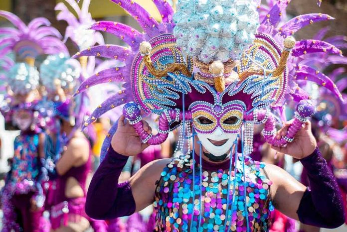 shutterstock_583294027 Dancer in ornate purple carnival mask and headdress