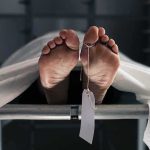 Human feet with toe tag on a morgue gurney