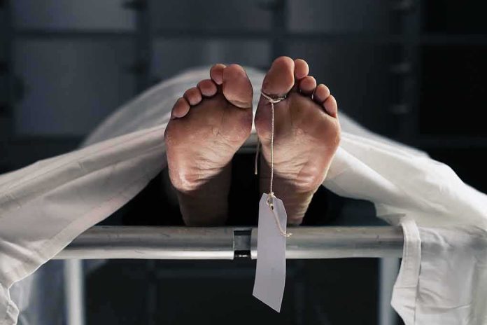 shutterstock_761983000 Human feet with toe tag on a morgue gurney