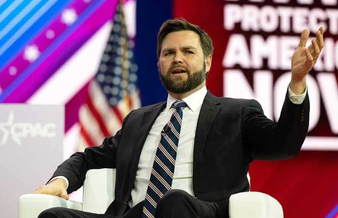 Man in suit speaking on stage during a panel discussion