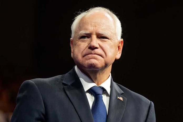 2499464677 Tim Walz in a dark suit and tie at an event