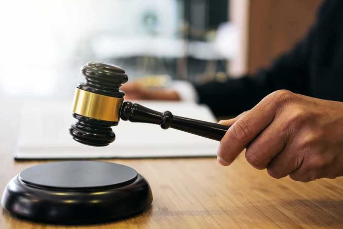 Judge's hand bringing a gavel down on the sound block