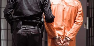 Serial Creep ARRESTED — AGAIN (and AGAIN)! Prisoner in orange jumpsuit handcuffed with guard standing beside