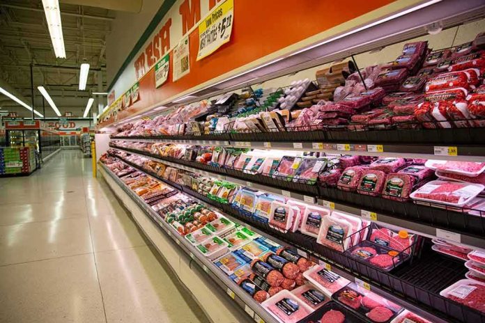 Grocery store meat aisle stocked with packaged beef and poultry