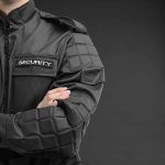 security guard in black uniform with crossed arms