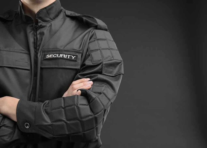 security guard in black uniform with crossed arms