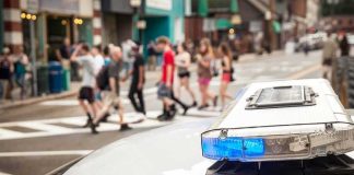 Near-Death DASH Stuns ONLOOKERS Police car lightbar with blue light near a busy crosswalk