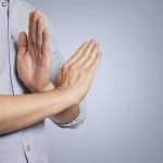 Person's hands making a stop gesture