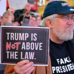 Andy Bryant at a protest holding a sign