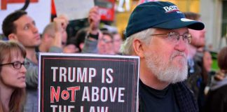 Andy Bryant at a protest holding a sign