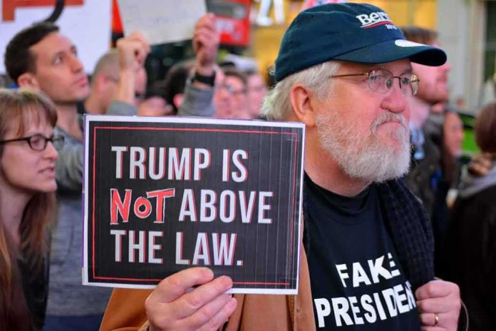 Andy Bryant at a protest holding a sign