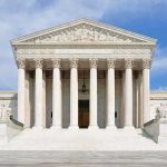Supreme Court SMACKS Down GUN GRAB Front view of the Supreme Court building with large columns and steps under a blue sky