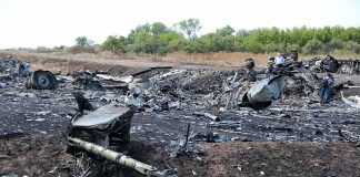 Airplane crash debris scattered across a burned field