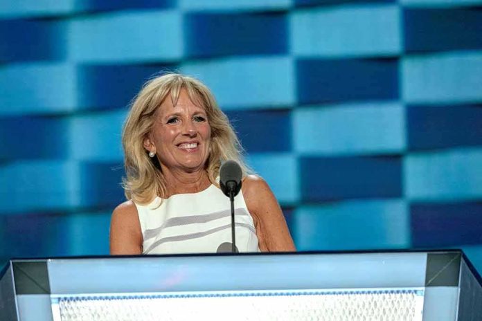 shutterstock_1362501617 Jill Biden speaking at a podium with a blue backdrop