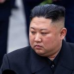 HIDDEN Heir Upends Kim Dynasty man in dark coat looking to the side