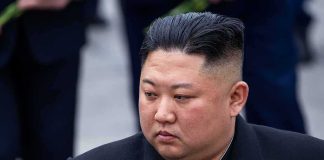 HIDDEN Heir Upends Kim Dynasty man in dark coat looking to the side