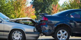 Two cars in a rear-end collision on a city street