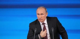Vladimir Putin at a podium with two microphones