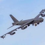 Military bomber aircraft banking in flight
