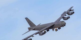 Military bomber aircraft banking in flight