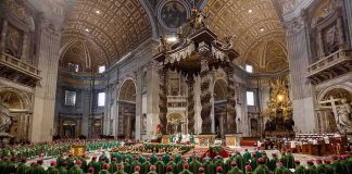 Jonathan Cyprien among clergy during a mass in a grand cathedral interior