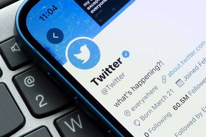 Smartphone showing Twitter profile page on a laptop keyboard