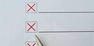 Checklist with red X marks and a silver pen