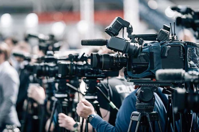 shutterstock_2197858977-1 Broadcast cameras on tripods at a press event