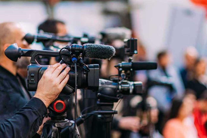 shutterstock_2233193507-1 Video cameras on tripods at a media event