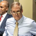 Man in glasses at a meeting table