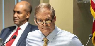 Man in glasses at a meeting table