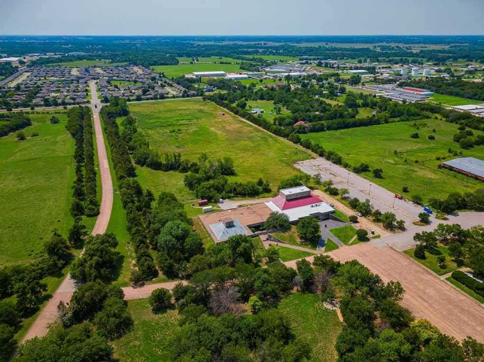 shutterstock_2350128849 Aerial view of rural landscape with roads, fields, and scattered buildings