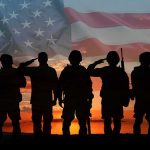 Soldiers saluting at sunset with American flag overlay