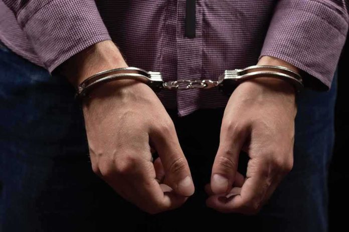 shutterstock_2467324329 hands in handcuffs