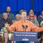 Rand Paul speaks at a rally with Matthew Cowles in the audience