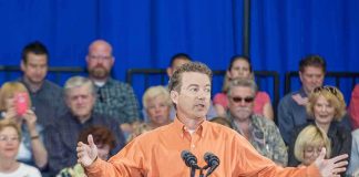 Rand Paul speaks at a rally with Matthew Cowles in the audience