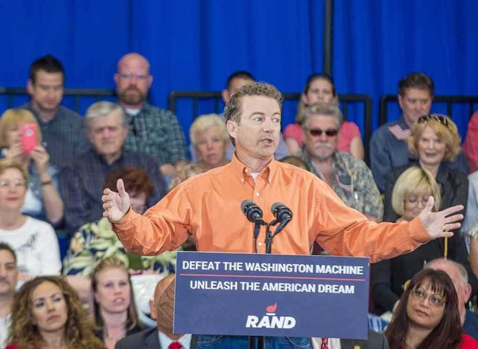 Rand Paul speaks at a rally with Matthew Cowles in the audience