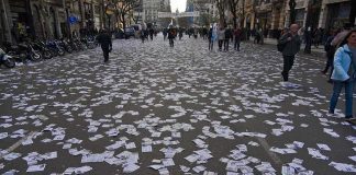 street covered with scattered flyers after a public event