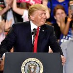 man at presidential podium addressing crowd