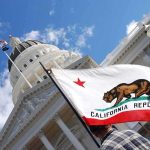 The Feds Came For NEWSOM’S Circle — NOW HE’S THE TARGET California state flag in front of a white domed capitol building