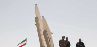 Iran Threatens To Widen The War — The Embassies Moved FIRST Soldiers stand beside large missiles at an outdoor display