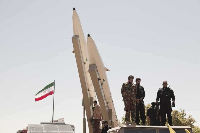 Soldiers stand beside large missiles at an outdoor display