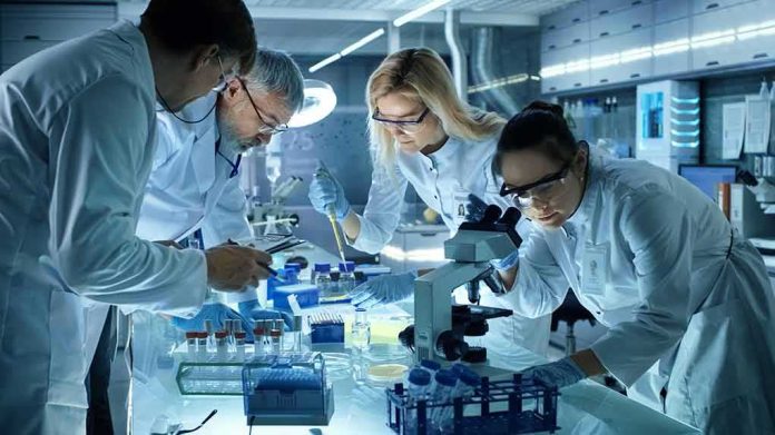 Scientists collaborating in a laboratory around a microscope
