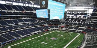 American football stadium interior with large central video board