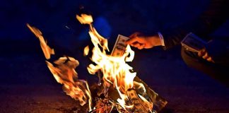 ICE Blew Your Tax Money With No Plan — See What It BOUGHT Hands burning cash over a small fire at night