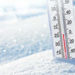 Thermometer in snow showing subzero temperature