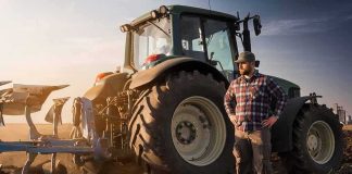 State Ruined Crops, Won’t Pay. Court TRASHES Its Excuse Farmer standing beside a tractor in a plowed field