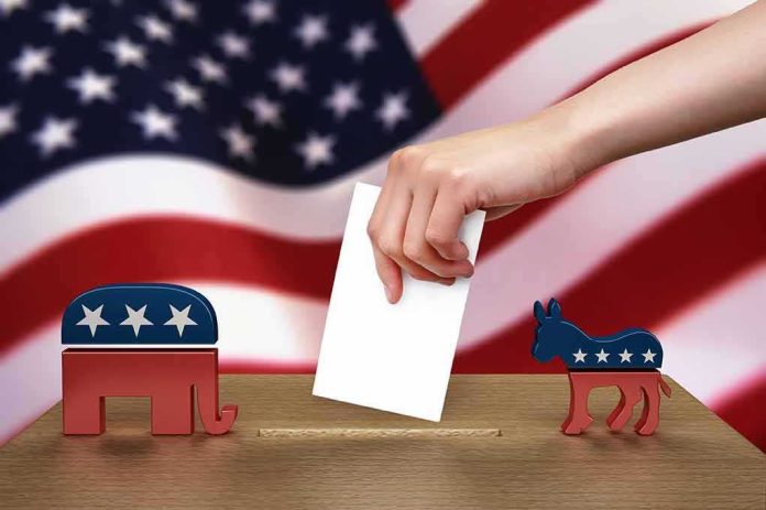 shutterstock_102884888 Hand casting ballot between Republican elephant and Democratic donkey